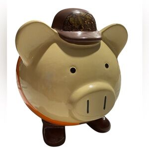 Large Piggy Bank with Mossy Oak Camo Hat and Orange and Camo Clothing. F.A.B. NY